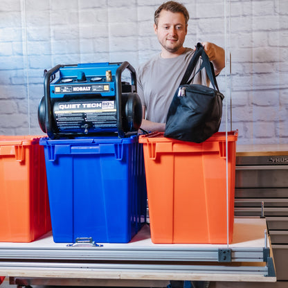 Auxx Attic-Lift platform at waist height loaded with bins, a compressor and a duffel bag